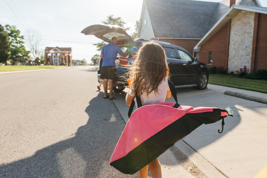 Family loading up the car after a game. 