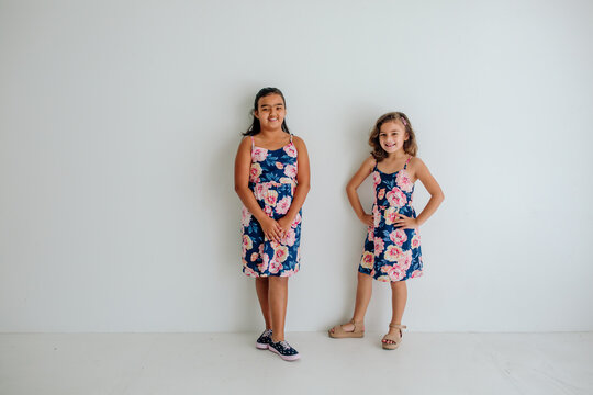 Happy sisters in matching dresses
