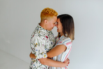 Female partners embracing nose to nose