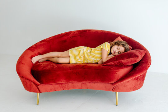 Girl Sleeping On Red Couch