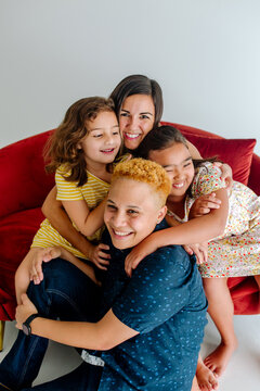 Happy family with bonus mom on sofa