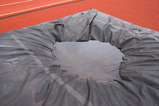 Pool of rainwater on grey tarp