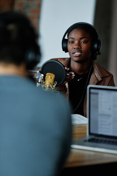 Woman recording podcast in studio