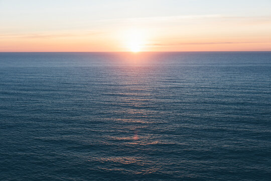 Setting sun over vast ocean