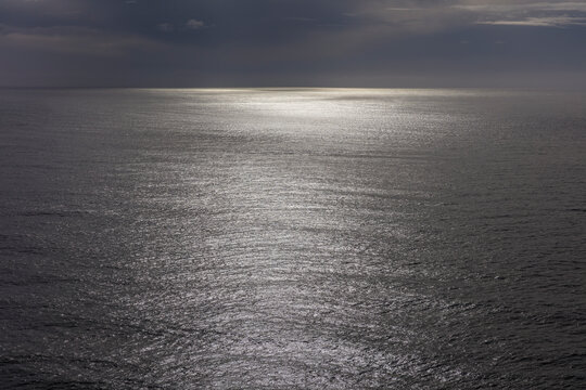 View of vast ocean, horizon and sky at dusk