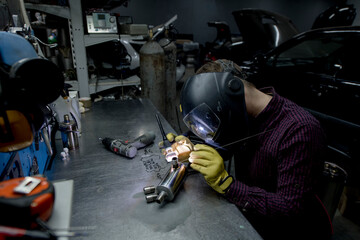 Man welding in his workshop