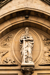Fototapeta na wymiar statue of st paul above a church in belfast.