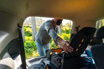 Man preparing backpack with drone for flight 