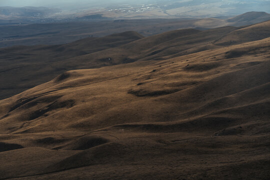 Hilly terrain covered with dry grass
