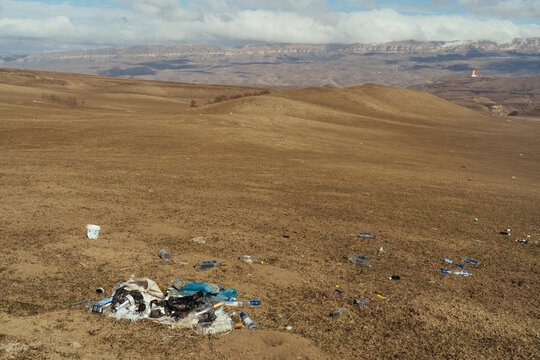 Trash on grassy hill in highlands