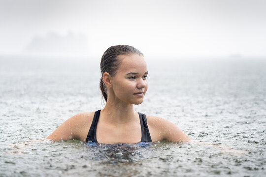 Young Woman Swimming in the Rain at Summer Cottage Vacation