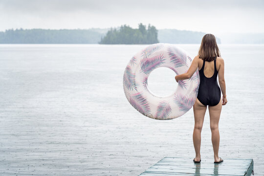 Young Woman Going for a Swim in the Rain at Summer Cottage Vacation Lake