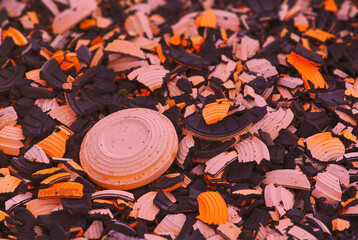 Shattered shotgun targets on the ground of shooting range with one target still being unbroken