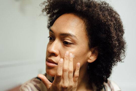 Close Up Of A Woman Putting Lotion On Her Face