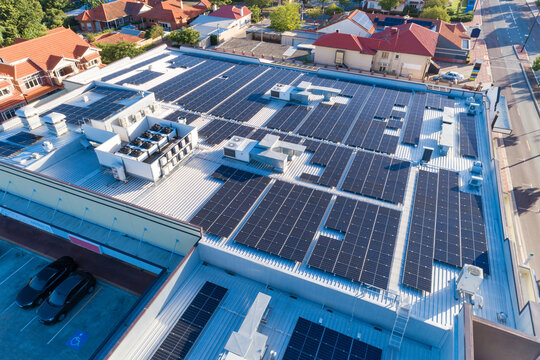 Aerial views over commercial building with over 600 solar panels installed