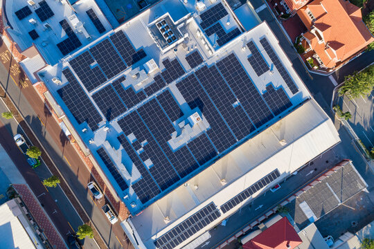 Aerial views over commercial building with over 600 solar panels installed