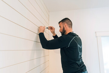  Handyman replacing a light fixture. 