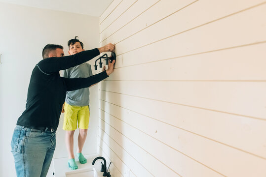 Boy distracted while father is working. 