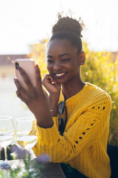 Happy African Woman Using Phone
