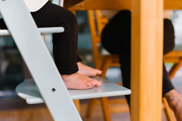 Toddler's feet in a high chair