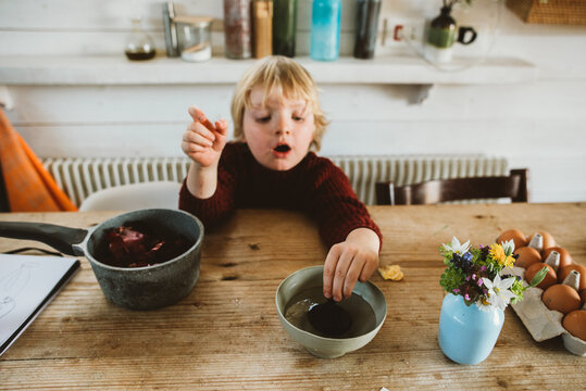 A toddler coloring easter eggs