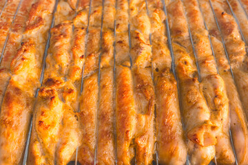 Cooking barbecue chicken meat food on the grill, close up