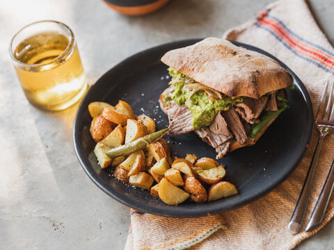 Steak sandwich with potatoes and avocado