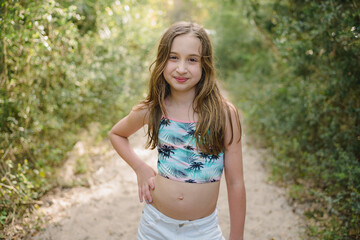 Portrait of a young girl in a swim top and shorts
