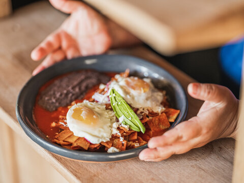 Red Chilaquiles with two fried eggs. 