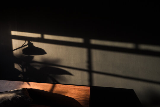 Sunset light on the dark wall in the bedroom