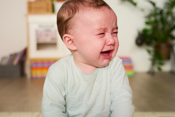 Adorable crying baby boy.