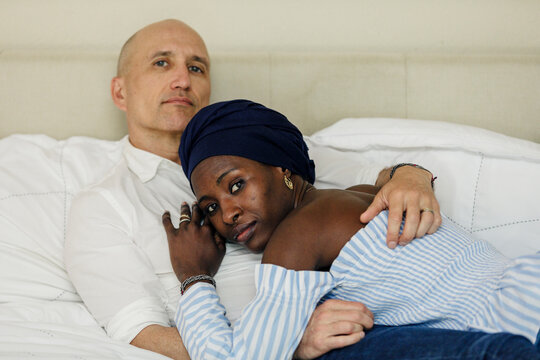 Biracial lovers at bed