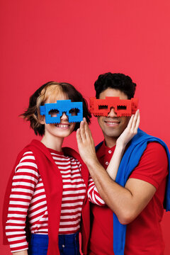 Cheerful multiracial couple in bright outfits and sunglasses