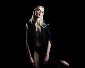 Naklejka premium Sensual fashion woman in trendy clothes. Sexy female posing in studio. High fashion model.