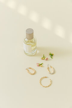 Still life of perfume bottle and jewelry