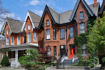 Fototapeta na wymiar Row of old Victorian semi-detached houses with gables, typical of older neighborhoods in downtown Toronto