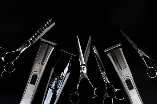 A set of hair cut tools on black background for cutting barber beard salon