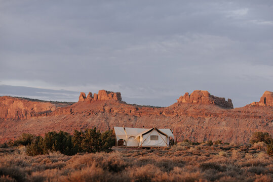 Canvas glamping tents at sunrise in the desert