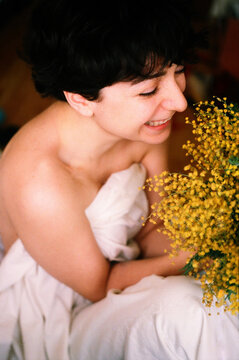 Smiling happy woman with a mimosa 