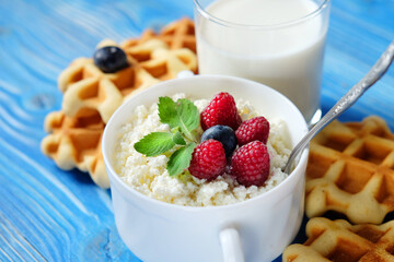 Cottage cheese with fresh berries, waffles and milk