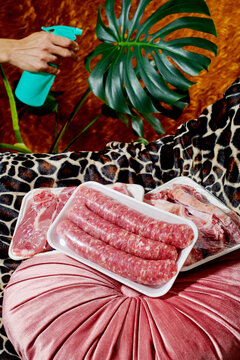 trays of raw sausages and lamb meat cuts