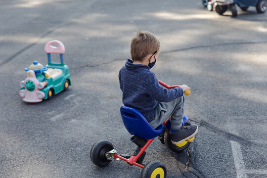Little boy riding a tricycle