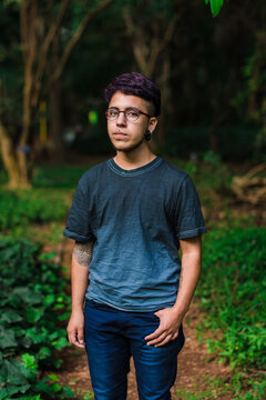 Young latino man standing in a park