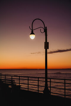 A street lamp near the ocean.