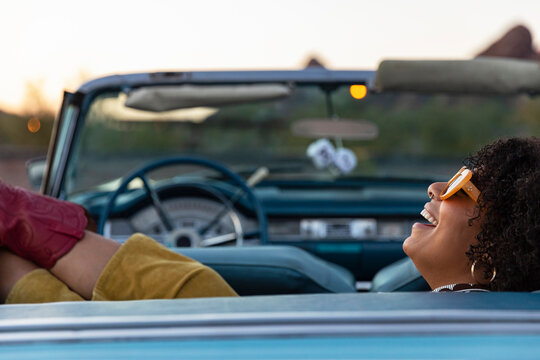 Young Cool  Girl Relaxing on Backseat of Convertible car 