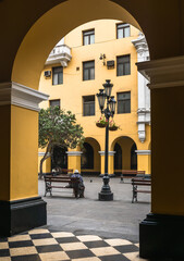 Fototapeta na wymiar Santa Rosa passage in the historic center of Lima, path with colonial yellow buildings