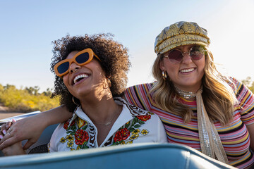 Happy Friends riding in the back of Convertible car 