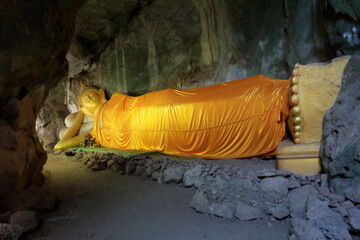 statue of buddha, with orange robe in  holly cave 