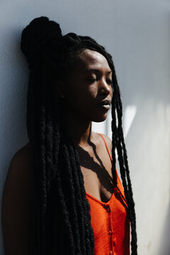 Portrait of beautiful black woman with dreadlocks hair and closed eyes