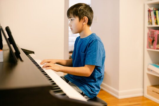 young boy playing the piano